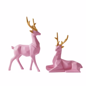Two pink geometric deer figurines with golden antlers – one standing and one sitting, minimalist decor style
