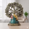 Decorative Buddha statue in colorful robes seated under a stylized Bodhi tree with detailed leaves.