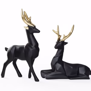 Black geometric deer figurines with gold antlers, one standing and one sitting, minimalist modern home decor set.