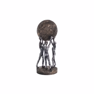 Decorative sculpture of three human figures lifting a textured globe, placed on a wooden table in a modern living room setting, symbolizing teamwork and unity.