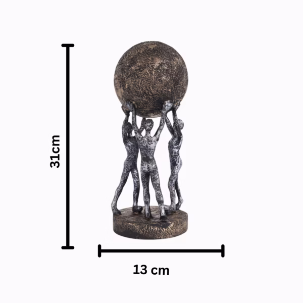 Decorative sculpture of three human figures lifting a textured globe, placed on a wooden table in a modern living room setting, symbolizing teamwork and unity.